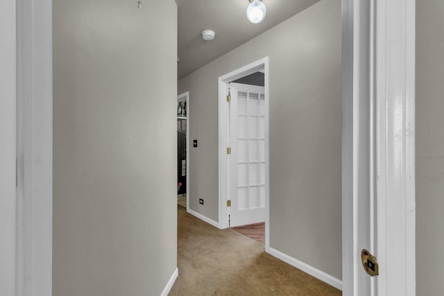 hallway with light colored carpet