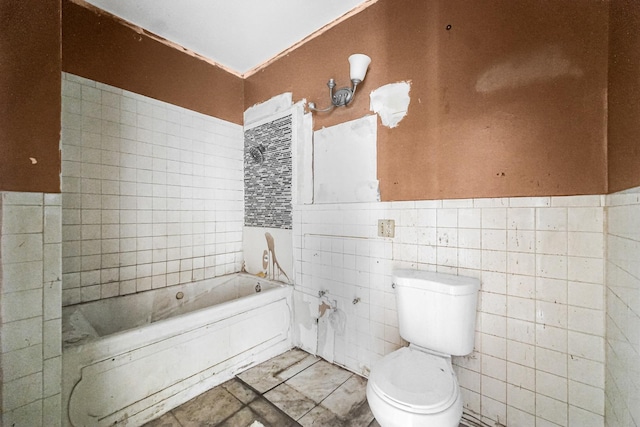 bathroom with toilet, tile walls, and a tub