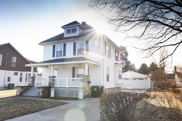 view of front of property featuring a porch, a garage, an outdoor structure, and central air condition unit