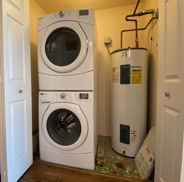 laundry area with water heater, stacked washer and dryer, and dark wood-type flooring