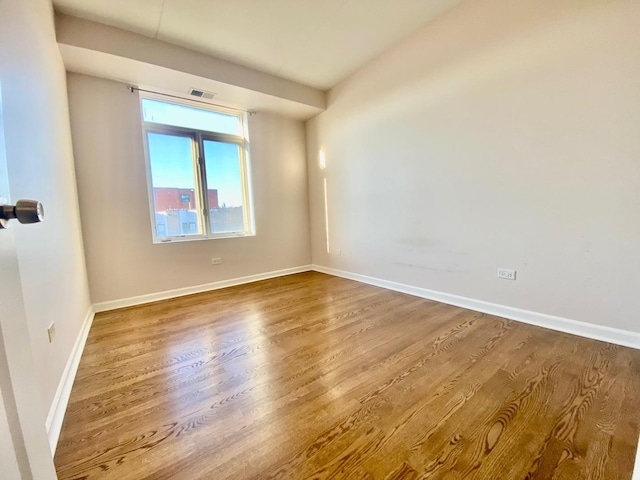 spare room with hardwood / wood-style flooring