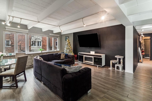 living room featuring beam ceiling, wood-type flooring, and track lighting