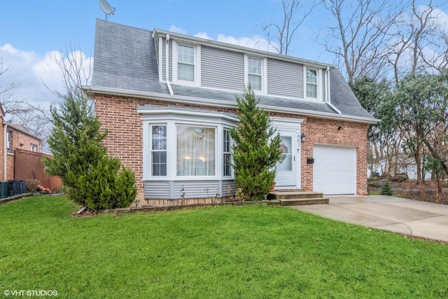 view of front of house featuring a front yard, a garage, and cooling unit