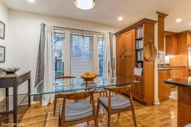 dining room with sink and light wood-type flooring