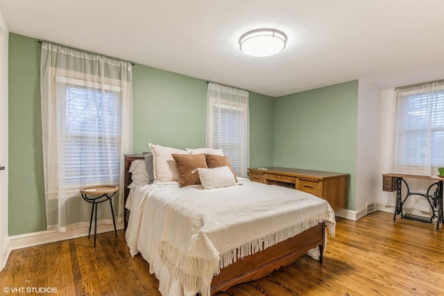 bedroom featuring hardwood / wood-style floors and multiple windows