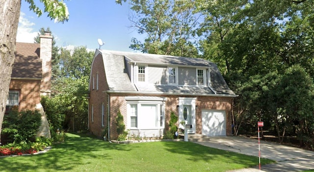 view of front of home with a front yard and a garage