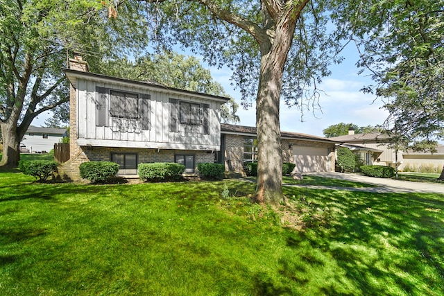 split level home featuring a front yard and a garage