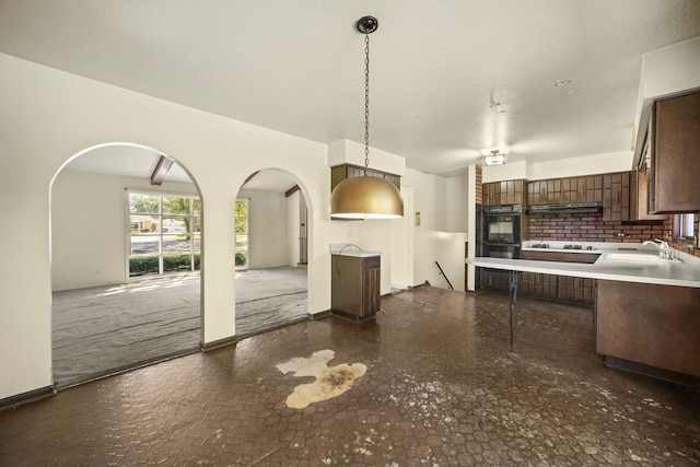 kitchen with backsplash, sink, hanging light fixtures, dark brown cabinets, and gas cooktop