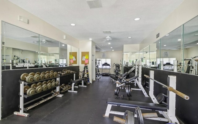 exercise room featuring a textured ceiling