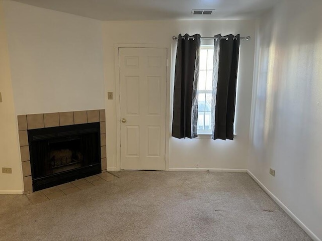 unfurnished living room featuring a fireplace and light carpet