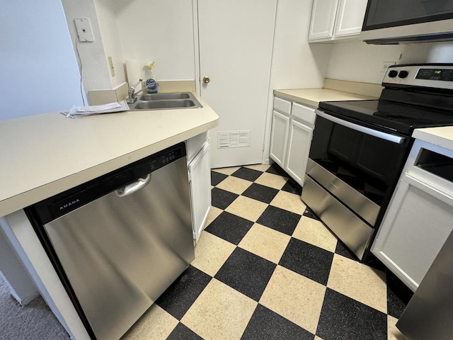 kitchen featuring white cabinetry, appliances with stainless steel finishes, and sink