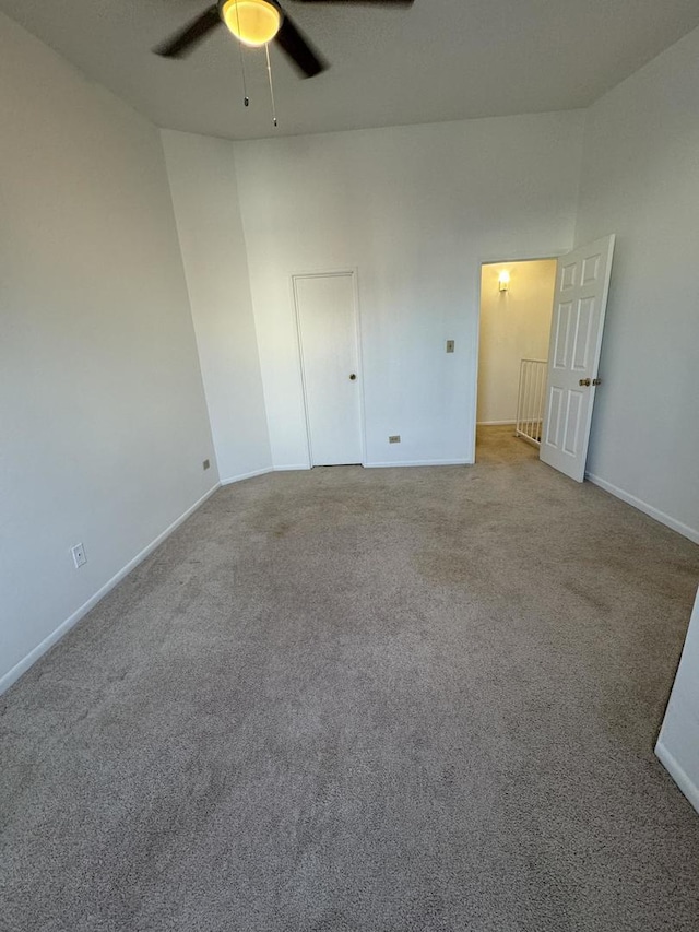 spare room featuring light carpet and ceiling fan