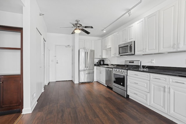 kitchen featuring ceiling fan, sink, stainless steel appliances, dark hardwood / wood-style floors, and white cabinets