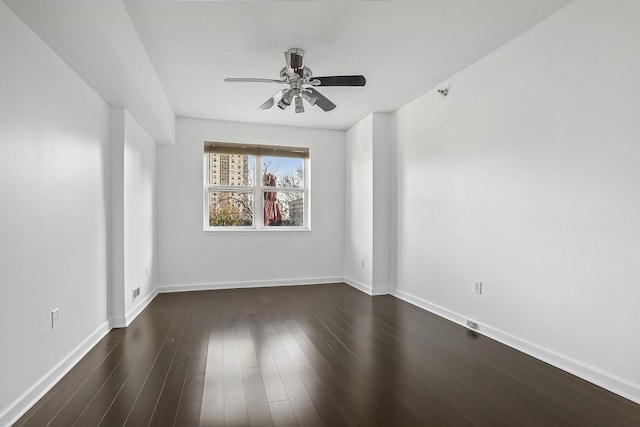 empty room featuring dark hardwood / wood-style floors and ceiling fan