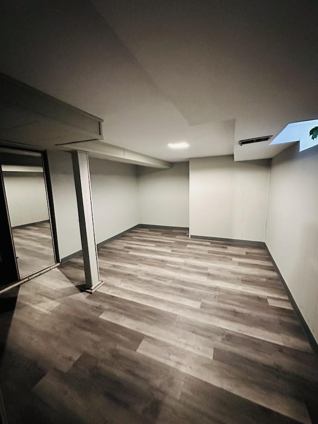 basement featuring hardwood / wood-style floors