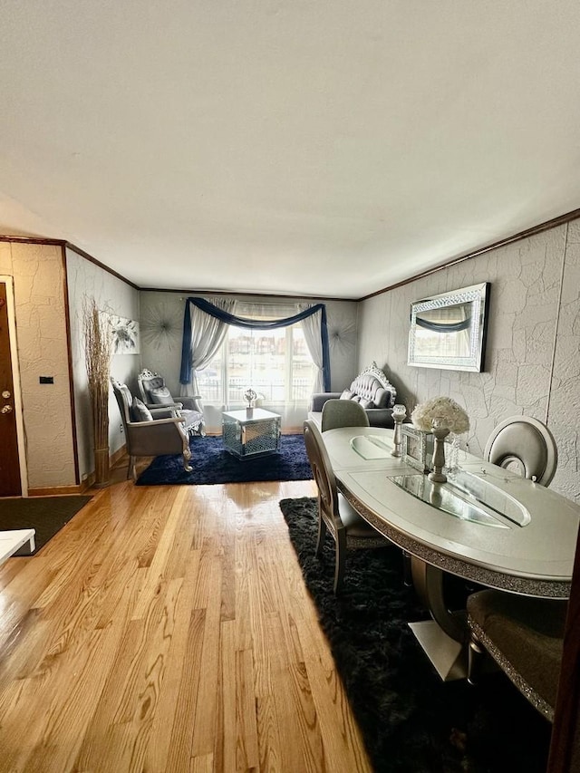 dining room with crown molding and hardwood / wood-style floors