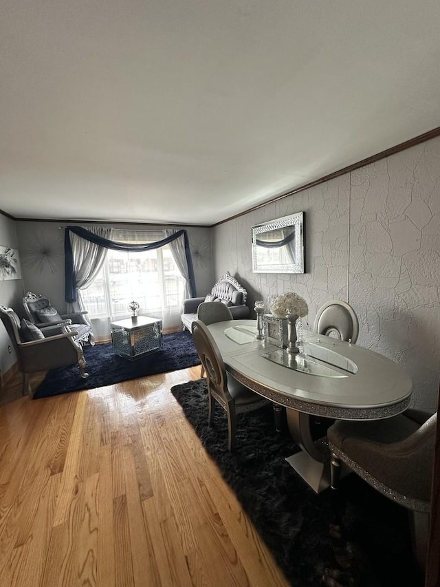 dining area with hardwood / wood-style floors and ornamental molding