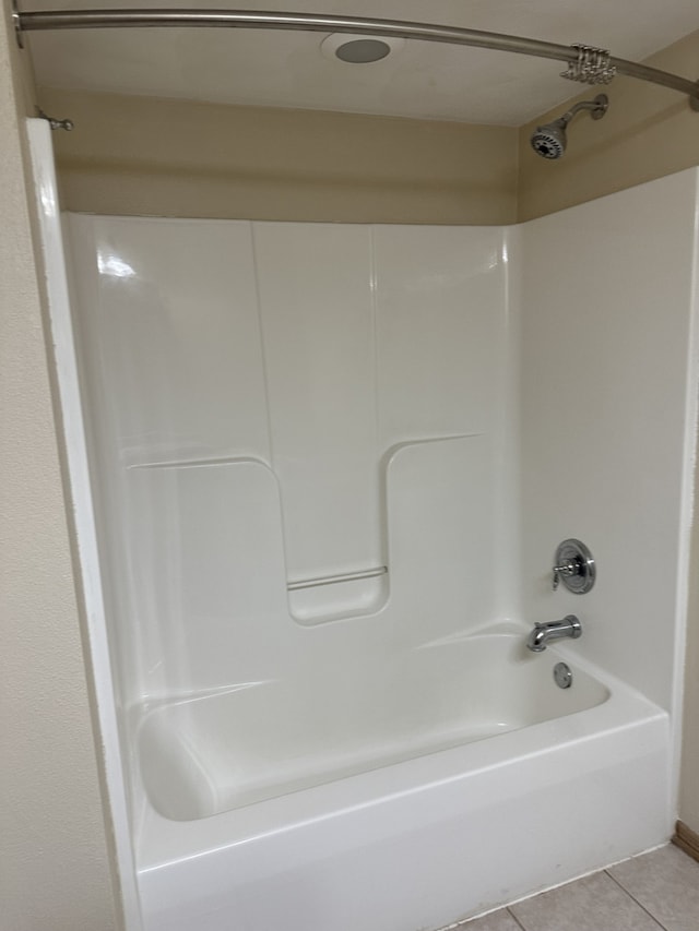 bathroom featuring tile patterned flooring and bathtub / shower combination