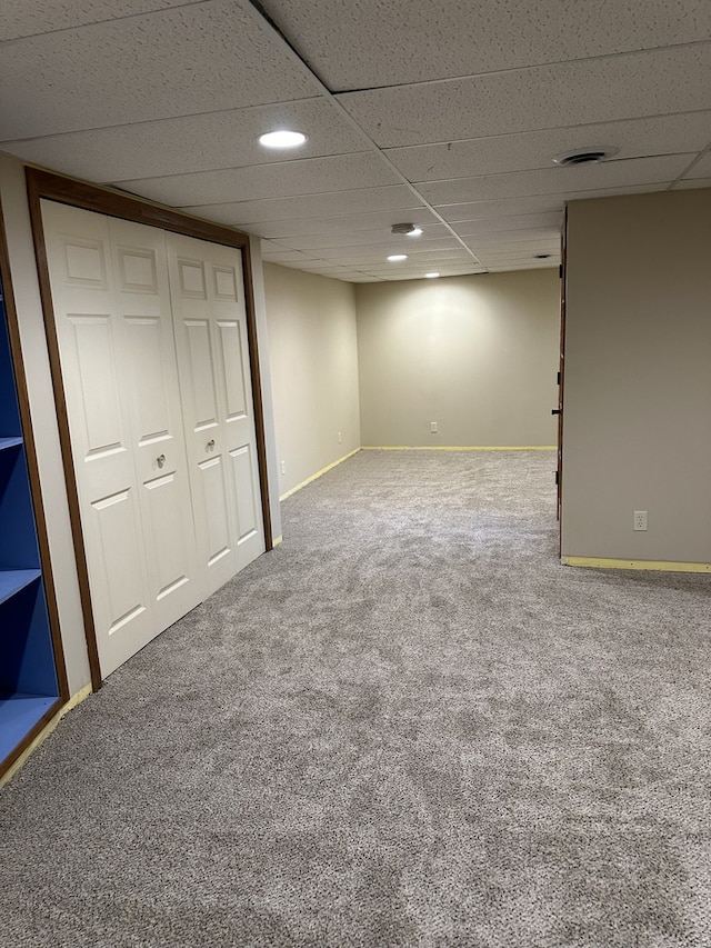 basement with carpet and a drop ceiling