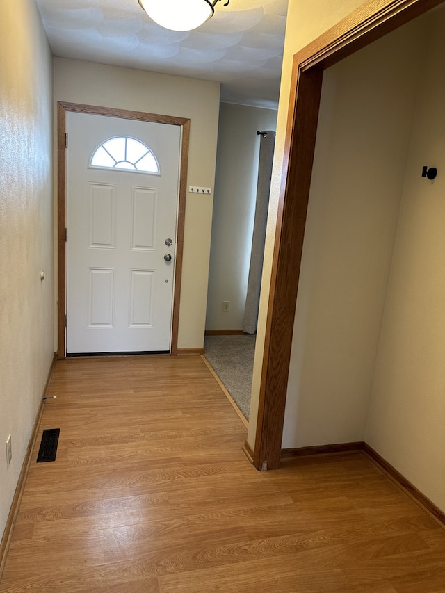 doorway to outside with light hardwood / wood-style flooring