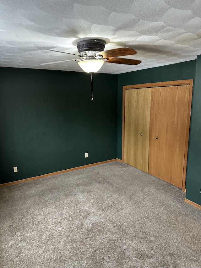 unfurnished bedroom featuring ceiling fan, carpet floors, and a closet