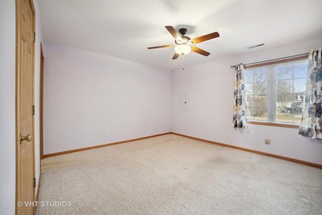 carpeted spare room featuring ceiling fan