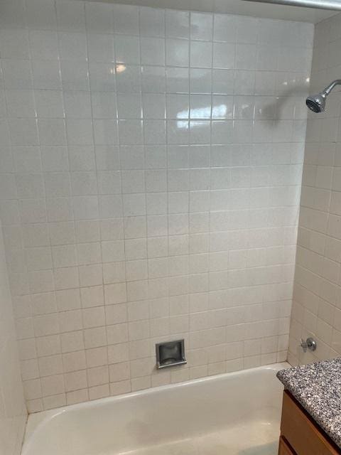 bathroom with vanity and tiled shower / bath combo