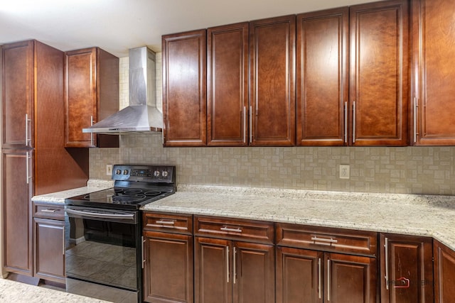 kitchen featuring black electric range oven, tasteful backsplash, light stone counters, light tile patterned flooring, and wall chimney range hood