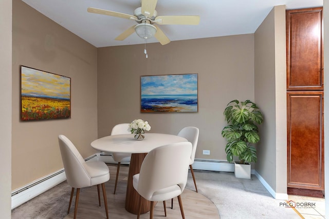 dining room featuring ceiling fan, a baseboard radiator, and light carpet