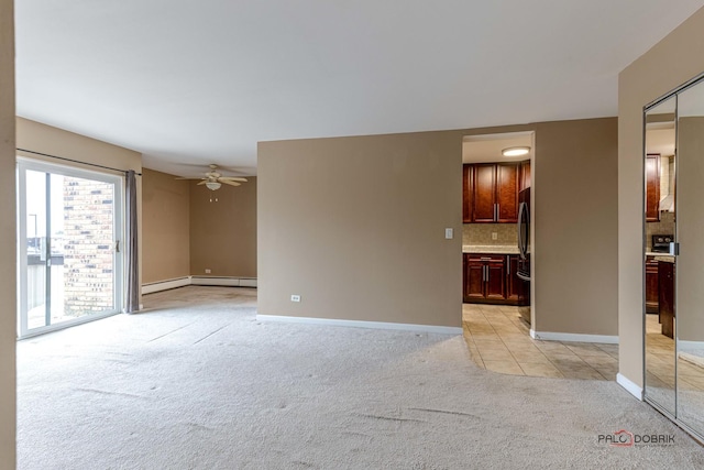 unfurnished room featuring ceiling fan, a baseboard heating unit, and light carpet