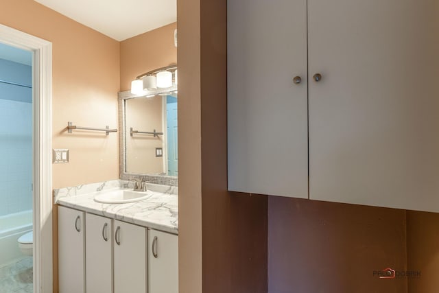 bathroom with toilet, tile patterned flooring, and vanity