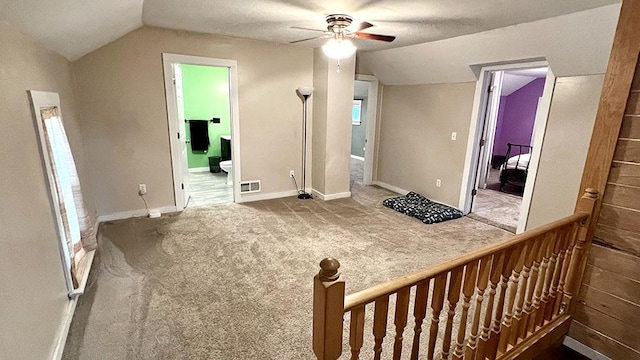 additional living space featuring a textured ceiling, ceiling fan, carpet, and lofted ceiling