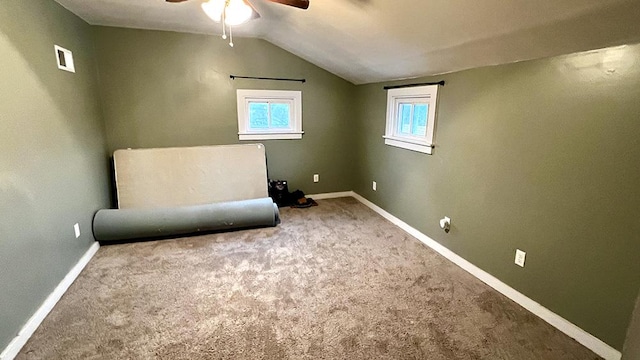 unfurnished room with carpet floors, vaulted ceiling, and ceiling fan