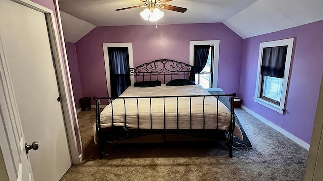 carpeted bedroom with ceiling fan and vaulted ceiling