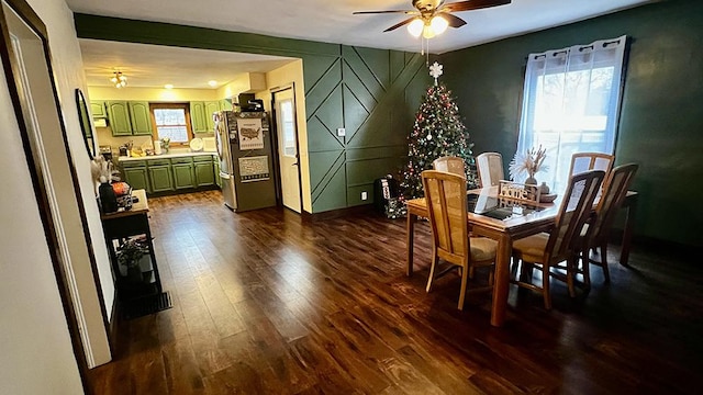 dining space with ceiling fan and dark wood-type flooring