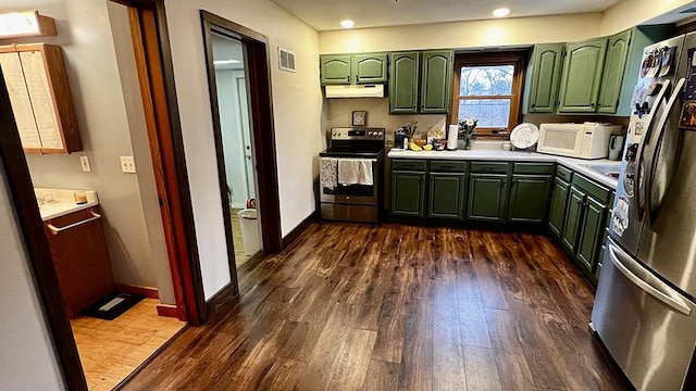 kitchen featuring stainless steel appliances, dark hardwood / wood-style floors, and green cabinetry