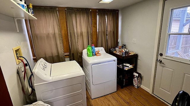 laundry area with hardwood / wood-style floors and washer and dryer