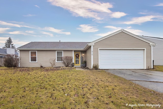 single story home with a garage and a front lawn