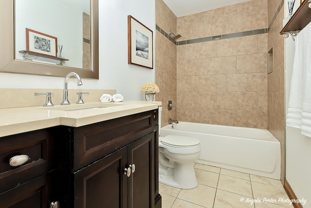 full bathroom featuring tile patterned flooring, vanity, toilet, and tiled shower / bath combo