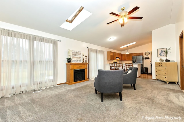 carpeted living room with ceiling fan and lofted ceiling