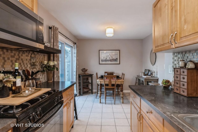 kitchen featuring tasteful backsplash, black range with gas stovetop, light brown cabinets, and light tile patterned floors