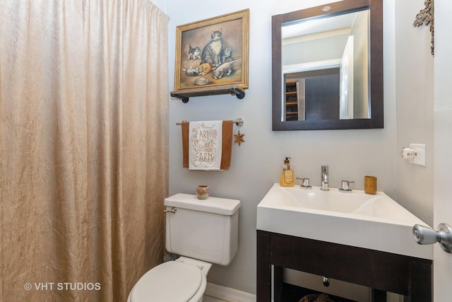 bathroom featuring vanity and toilet