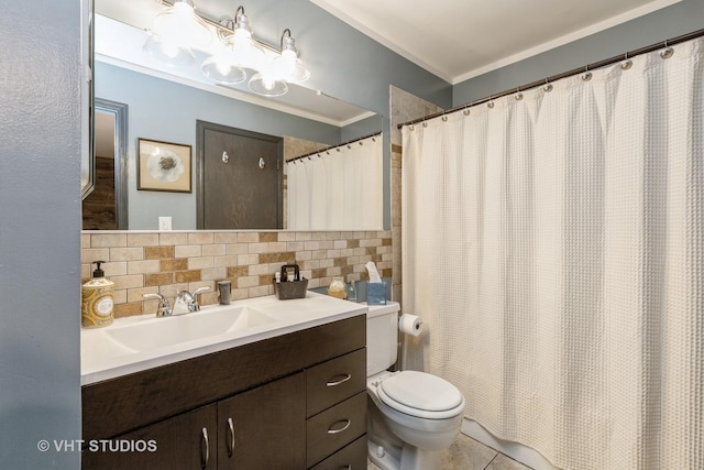 bathroom featuring tile patterned floors, toilet, crown molding, vanity, and backsplash