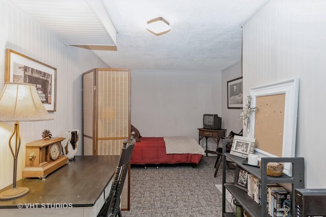 carpeted bedroom with a textured ceiling