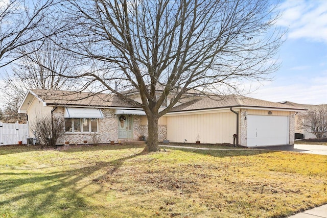 ranch-style house with cooling unit, a front yard, and a garage