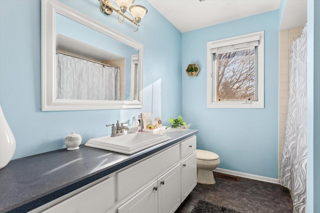 bathroom featuring vanity and toilet