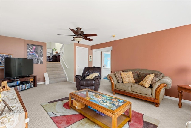 carpeted living room featuring ceiling fan