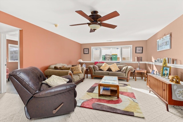 living room featuring light carpet and ceiling fan