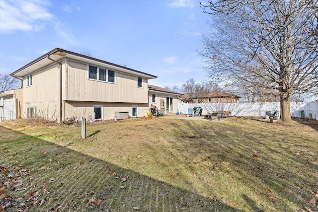 rear view of property with a lawn