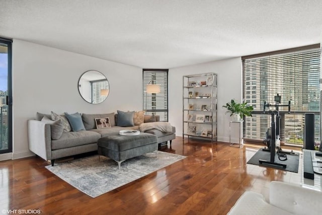 living room featuring dark hardwood / wood-style floors and a textured ceiling